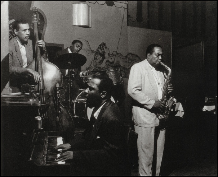 Charlie Parker (sax) Monk (piano) Mingus (bass) and Roach (drums) at a session