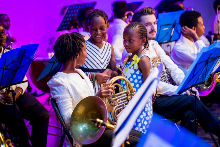 Children aged below 10 years enjoying their time with orchestra members