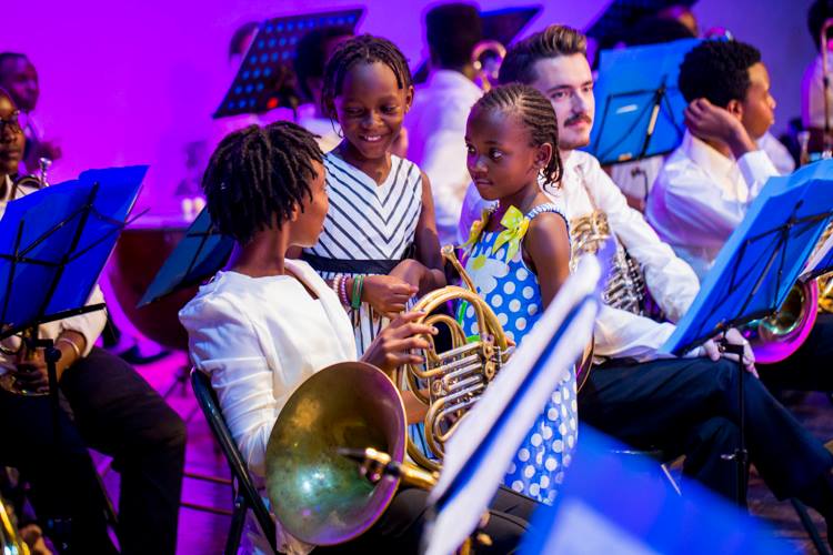 Children aged below 10 years enjoying their time with orchestra members