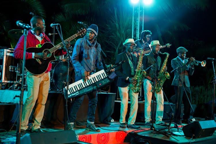 Tim Riungu performing alongside  Chris Adwar  Adorned with a fedora hat